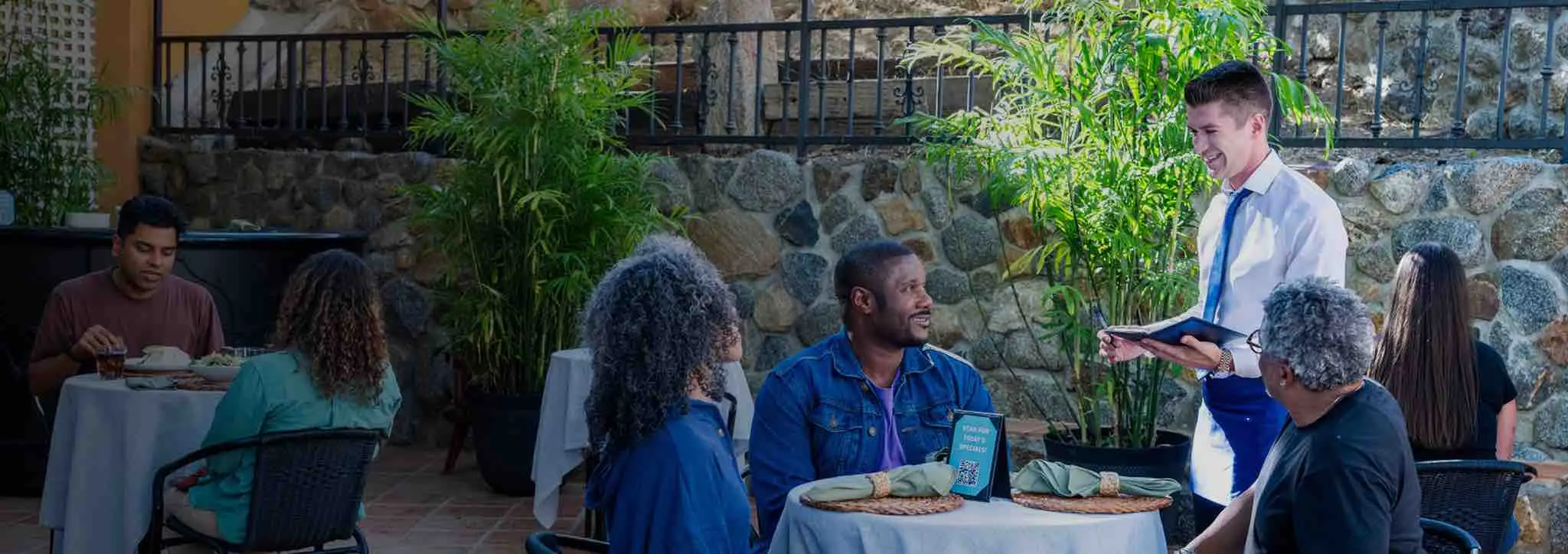 A family having a conversation during their meal at a restaurant
